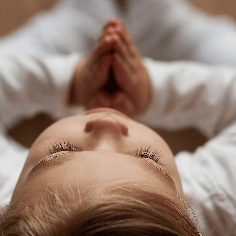 a child practicing gratitude with hands in namaste position